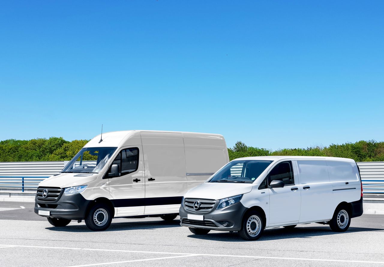 Crafting Captivating Headlines: Your awesome post title goes here Two white delivery vans parked in a spacious parking lot under a clear blue sky.